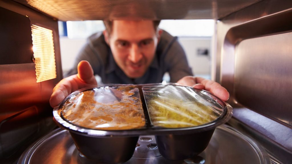 man putting a Plastic Bag In The Microwave
