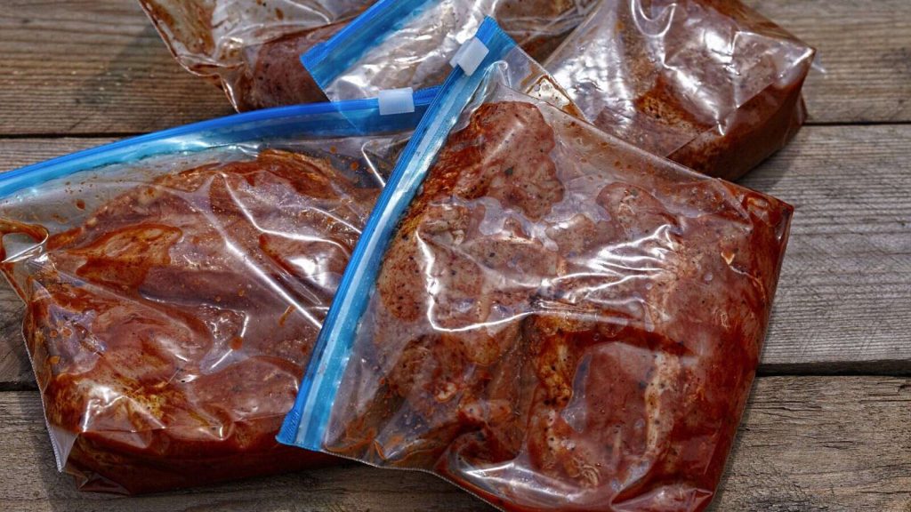Meat with barbecue sauce in plastic sealed bag