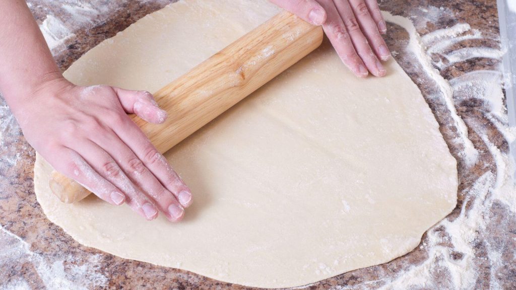 Rolling dough on floured surface