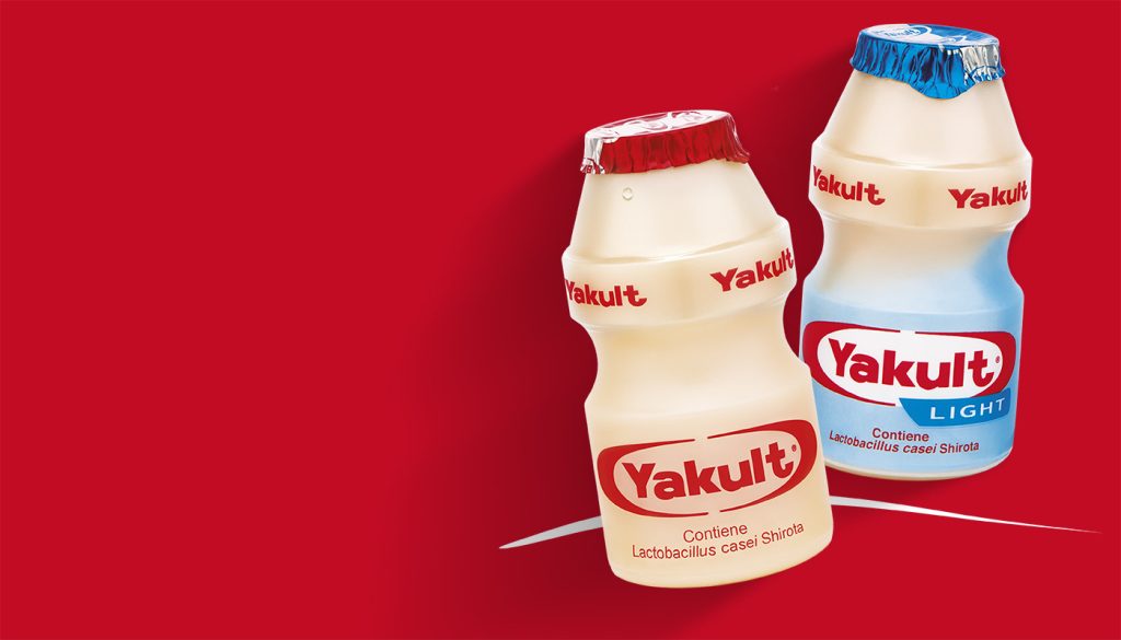 Yakult bottles on red background